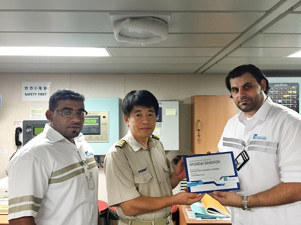 ADPC staff present the captain of Hyundai Bangkok with a plaque marking her maiden call to the port. ADPC staff present the captain of Hyundai Bangkok with a plaque marking her maiden call to the port.