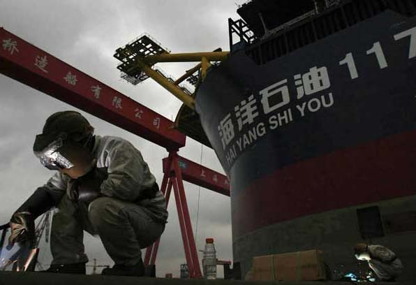 Man at work in Chinese shipbuilding yard Man at work in Chinese shipbuilding yard