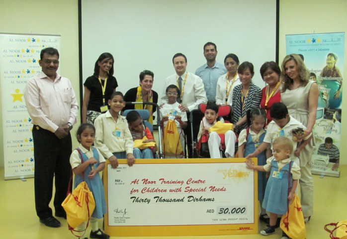 DHL Express staff with children and staff from the Al Noor Centre DHL Express staff with children and staff from the Al Noor Centre