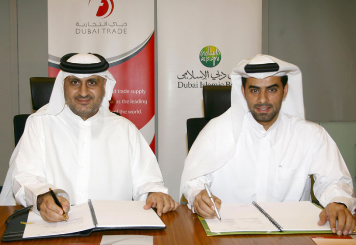 Mahmood Al Bastaki, director, Dubai trade, and Musabbah Al Qaizi, head of electronic banking, DIB, signing the agreement. Mahmood Al Bastaki, director, Dubai trade, and Musabbah Al Qaizi, head of electronic banking, DIB, signing the agreement.