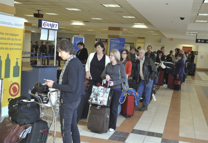 Passengers wait in line at Halifax (George Pimentel/Getty Images). Passengers wait in line at Halifax (George Pimentel/Getty Images).