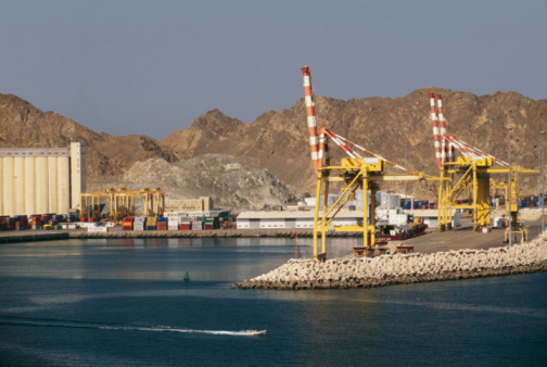 Heavy cranes are seen at the dock under sunlight Heavy cranes are seen at the dock under sunlight