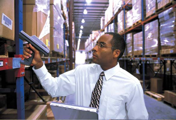 Man looks at shelving Man looks at shelving