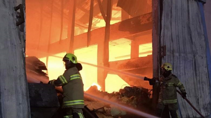 The blaze broke out in a furniture warehouse in the Al Jarf area and quickly spread to three other warehouses. The blaze broke out in a furniture warehouse in the Al Jarf area and quickly spread to three other warehouses.