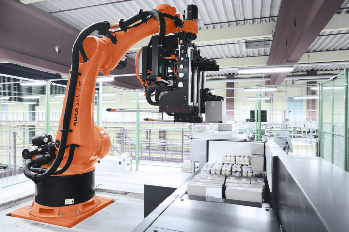 The heart of the new system will be three RowPaQ robot cells, which can each handle up to four cases simultaneously and stack up to 1,000 cases per hour into multi-product pallet loads ready for customer delivery. The heart of the new system will be three RowPaQ robot cells, which can each handle up to four cases simultaneously and stack up to 1,000 cases per hour into multi-product pallet loads ready for customer delivery.